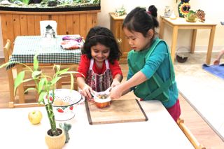 Here, a multi-age group cuts an apple